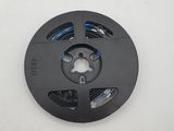 a close up of a black spool on a white surface