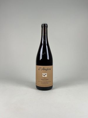 a bottle of wine sitting on top of a white table