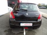 a small black car parked on the side of the road
