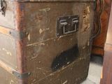 an old trunk sitting on the floor next to a table