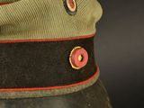 an image of a military hat with a red stripe around the brim