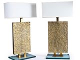 pair of brass and glass table lamps with white lampshads