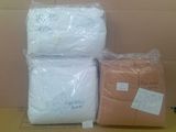 three bags of toilet paper sitting on top of a cardboard box