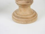 a small statue of a man with a hat on a pedestal