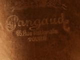 a close up of a wooden vase with a label on it