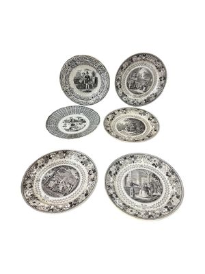 six plates with black and white designs on them on a white surface