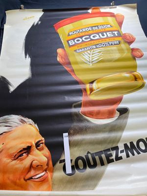 a large poster of a man holding a cup of coffee
