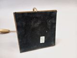 a small black box with a wooden handle on a white surface