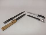 two knives and a knife holder on a white surface