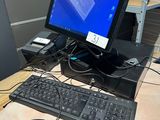 a computer desk with a keyboard, mouse, and monitor