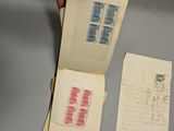 a person holding a piece of paper with stamps on it