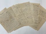 several old papers are stacked on top of each other on a table