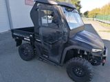 a black utility vehicle parked in front of a building