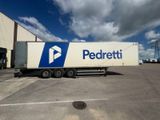 un semi-remorque garé devant un immeuble