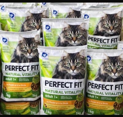 many bags of cat food sitting on a shelf