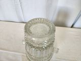 a clear glass jar on a table with a white cloth