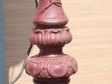 a red fire hydrant sitting on the side of a building
