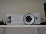 an image of a projector sitting on top of a shelf