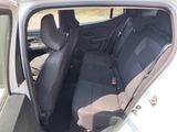 the back seats of a white car with a black seat belt