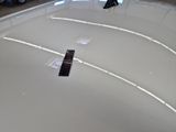 a remote control sitting on the hood of a car