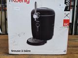 packaging of a black coffee maker sitting on top of a wooden table