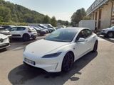 une Tesla Model S blanche garée sur un parking