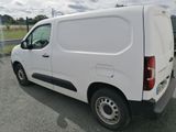 a white van that is parked on the side of the road