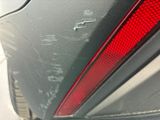 a close up of a car ' s tail light with writing on it