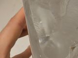 a person holding a clear glass object in their hand