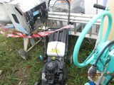 a black suitcase sitting on the ground next to a blue hose
