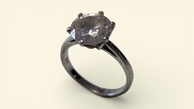 a close up of a diamond ring on a white surface