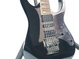 an image of a black electric guitar on a stand