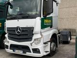 two trucks parked next to each other in front of a building