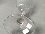 two empty wine glasses sitting on a table