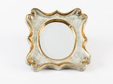an image of a small mirror with a gold frame