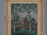 painting on easel of a landscape with a house in the distance