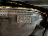 a close up of a black purse with a gold zipper