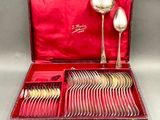 a red box with silverware in it on a table