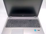a silver laptop with a blue sticker on it