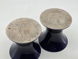 two black pedestals on a white surface