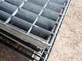 a metal grate that has been placed on the ground