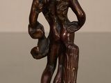 bronze statue of a man with a bird on his shoulder