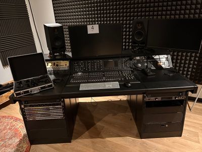 a desk with two monitors and a laptop on it