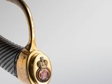 an image of a close up of a sword with a gold handle