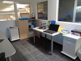 a desk with a laptop on it in an office