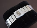a silver bracelet that has a monogram on it