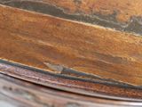 a close up view of a wooden table with a metal base