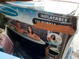 a box of inflatable bathtubs sitting on the ground