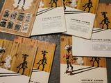 several cards with images of cowboys on them sitting on a table