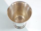 a silver cup that is sitting on a table